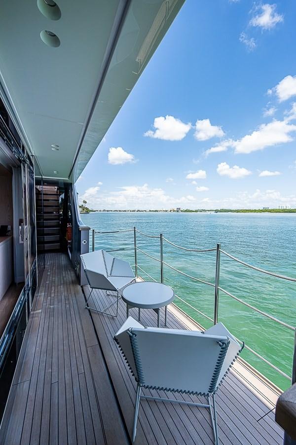 a deck with chairs and a body of water aboard F 118 Yacht for Sale