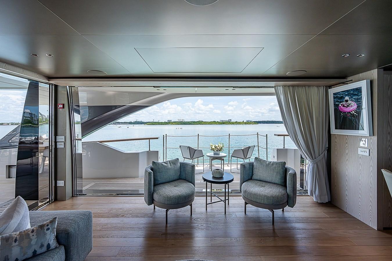 a room with a table chairs and a large window aboard F 118 Yacht for Sale