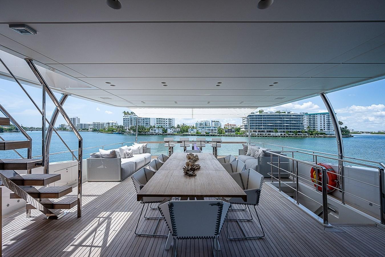 a deck with a table and chairs on it aboard F 118 Yacht for Sale