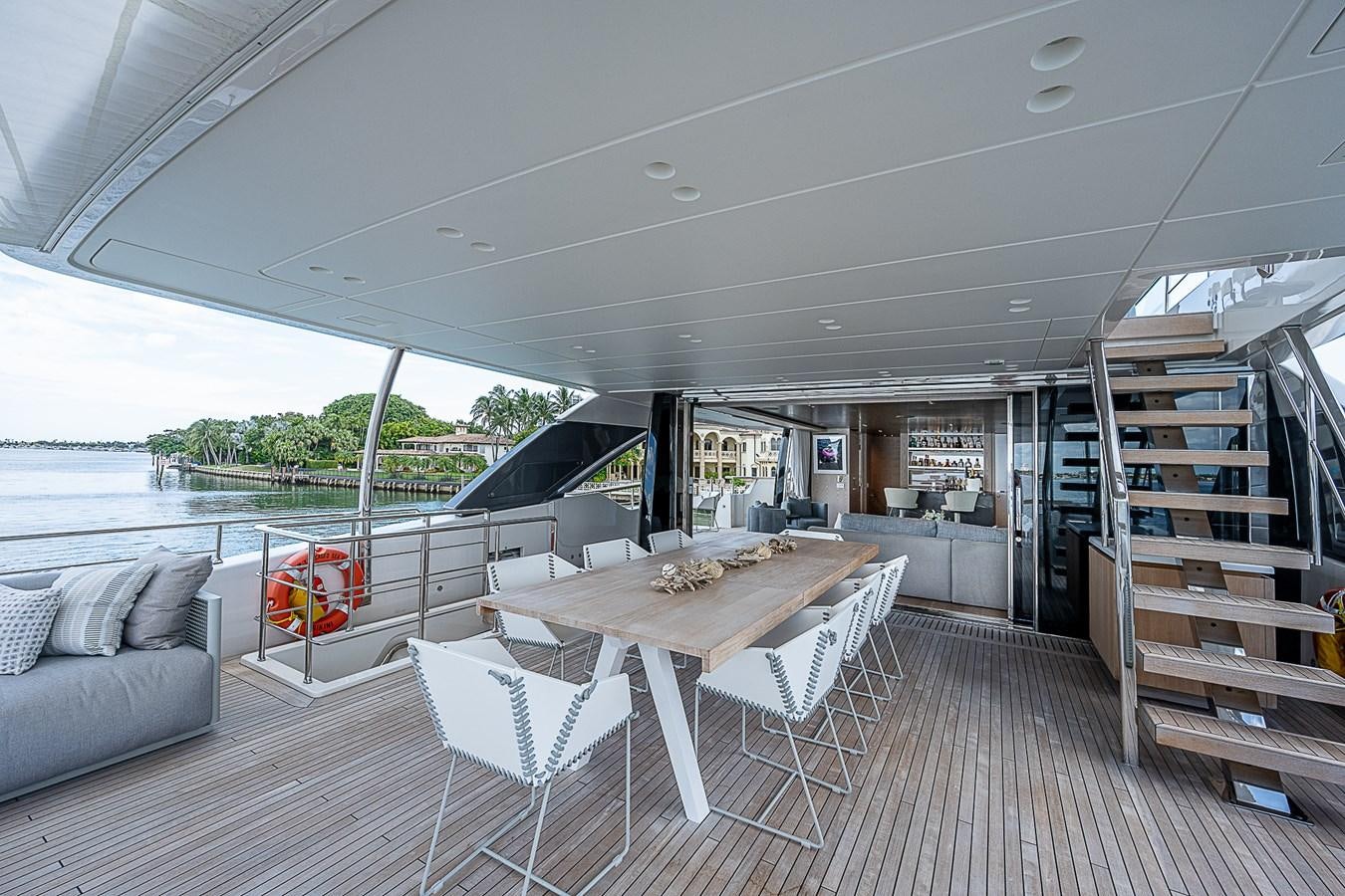 a large open area with a table and chairs and a couch aboard F 118 Yacht for Sale