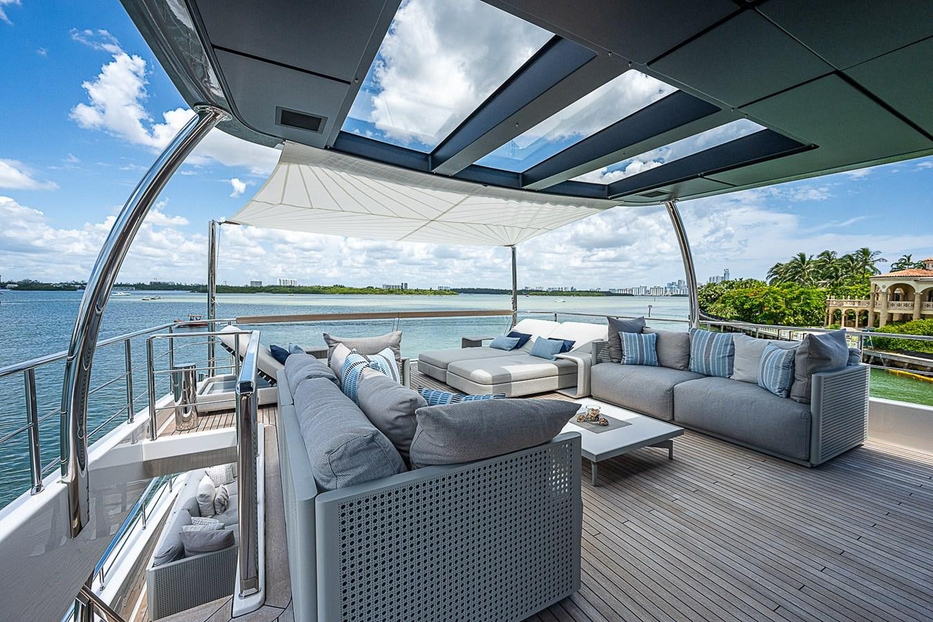 a large lounge area with a large deck and a large body of water aboard F 118 Yacht for Sale