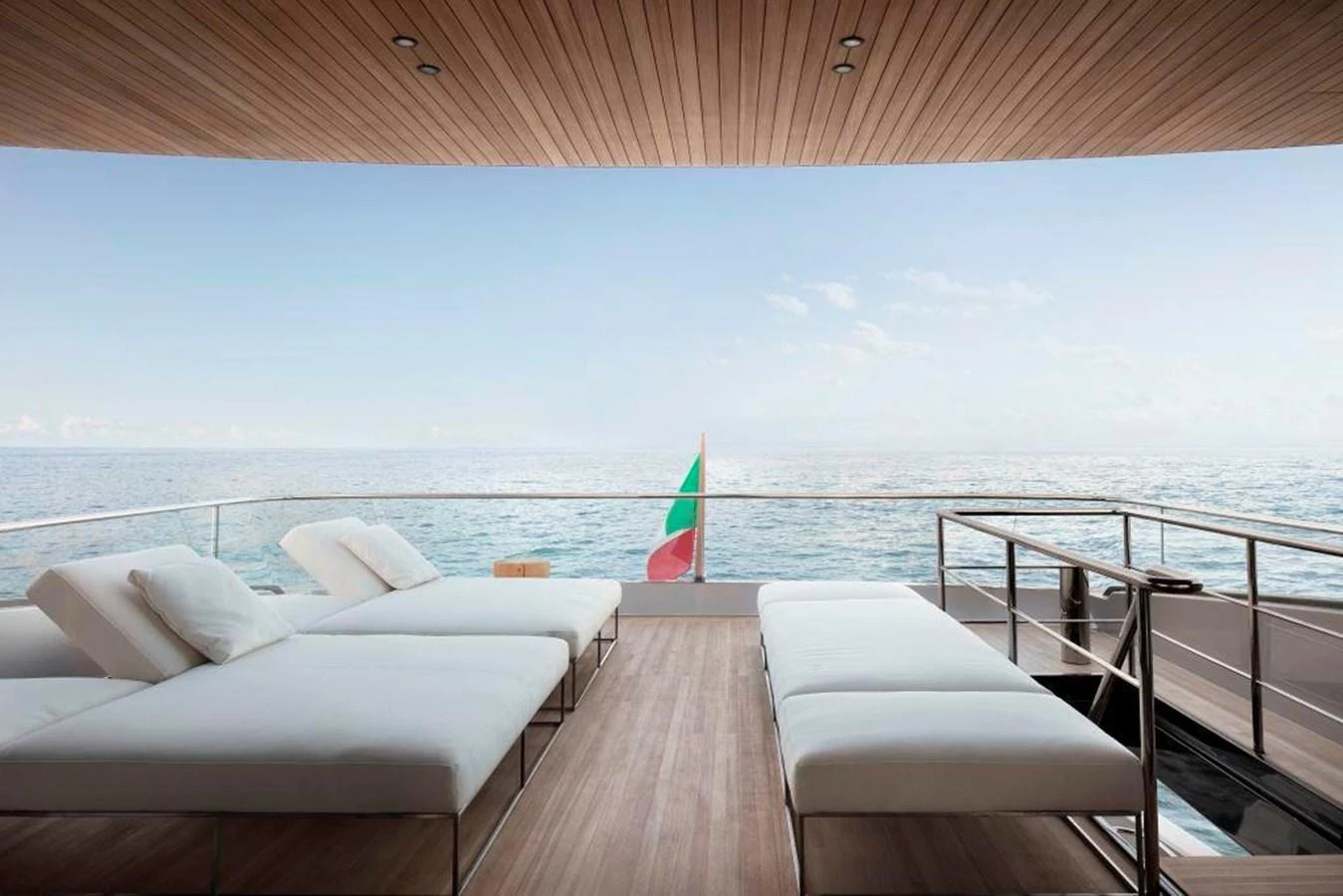 a deck with a beach and a umbrella aboard ALMAX Yacht for Sale