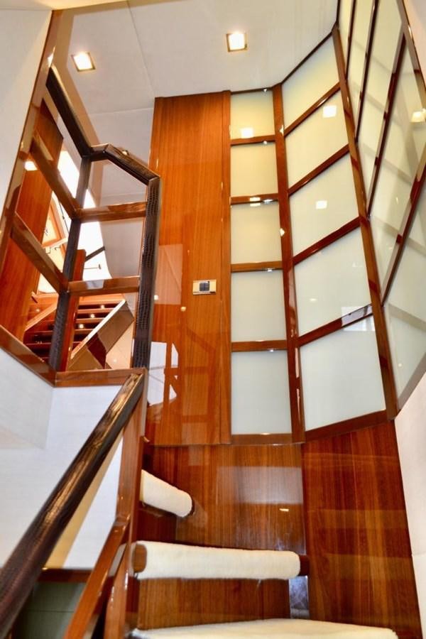a wooden staircase with wooden railings aboard ASPIRATION Yacht for Sale