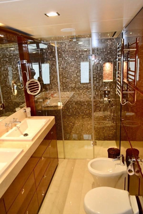 a bathroom with a glass shower aboard ASPIRATION Yacht for Sale