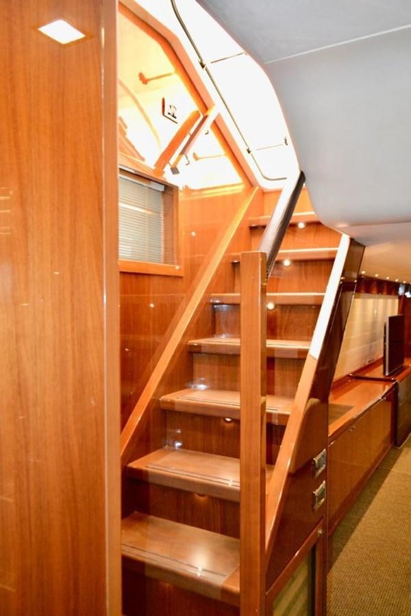 a wooden staircase with a wood railing aboard ASPIRATION Yacht for Sale