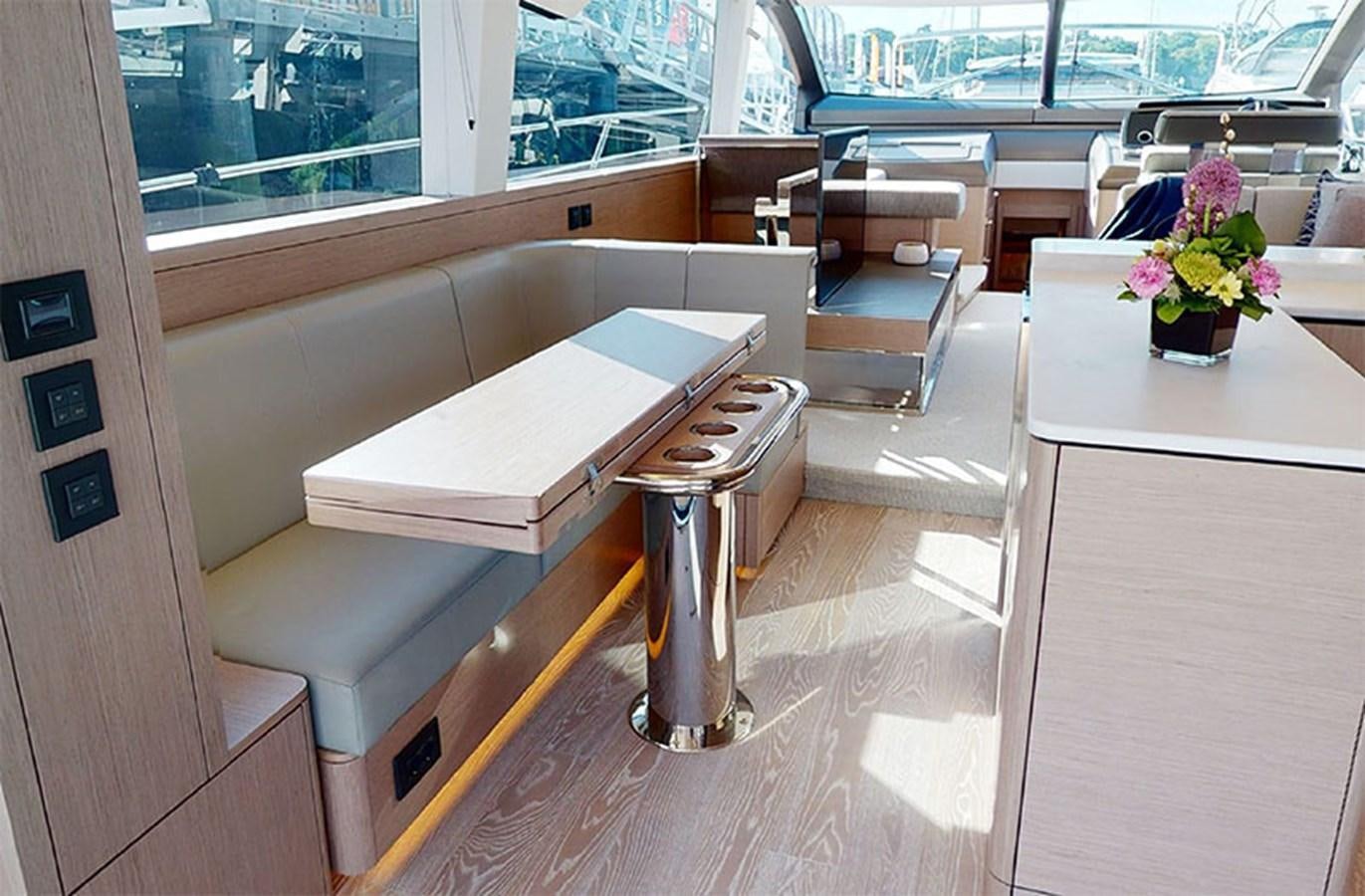 a room with a table and chairs aboard SM Yacht for Sale