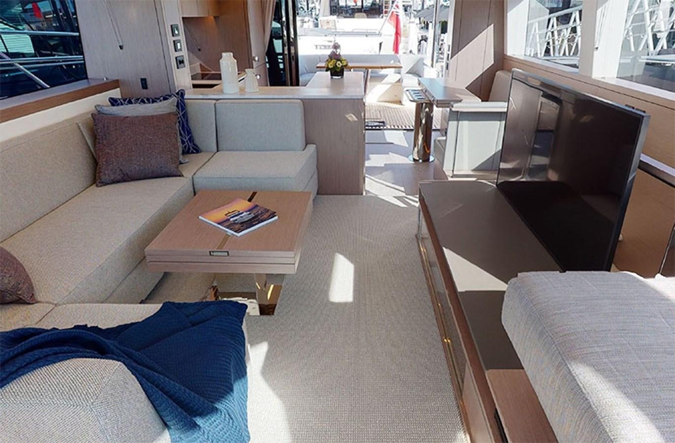 a living room with a couch and a coffee table aboard SM Yacht for Sale