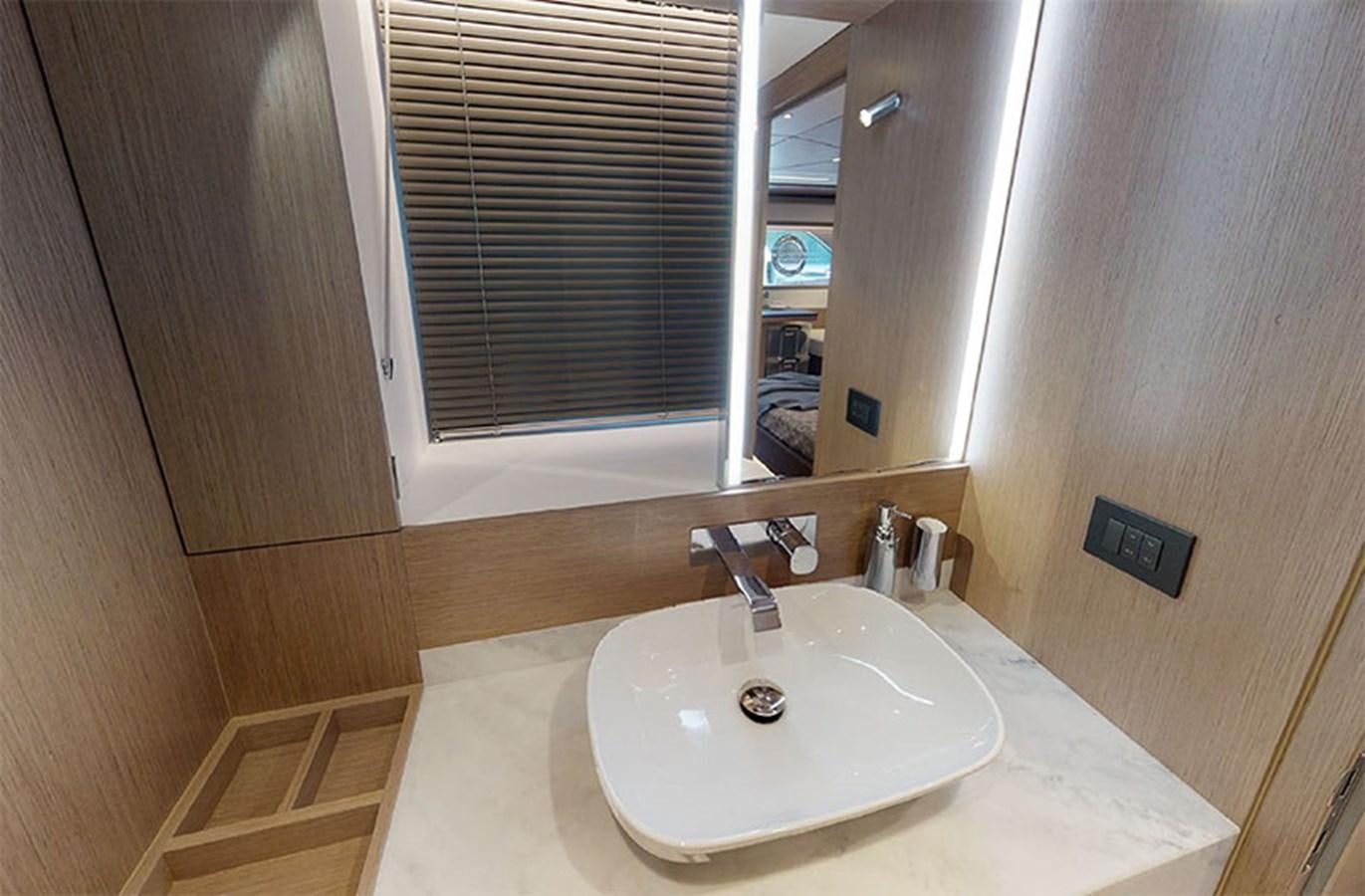 a bathroom with a sink and a mirror aboard SM Yacht for Sale