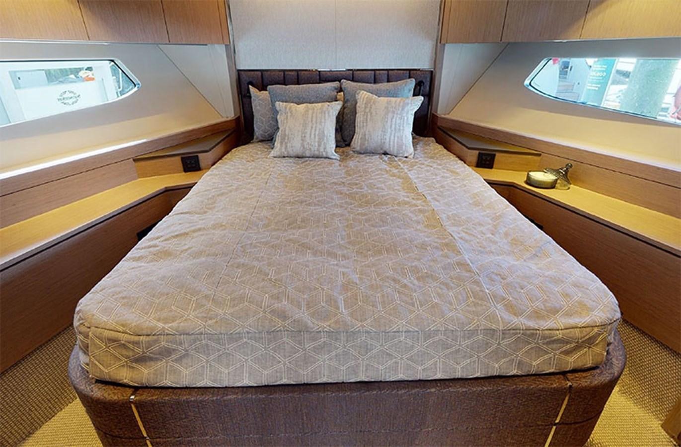 a bed with a television on the wall aboard SM Yacht for Sale