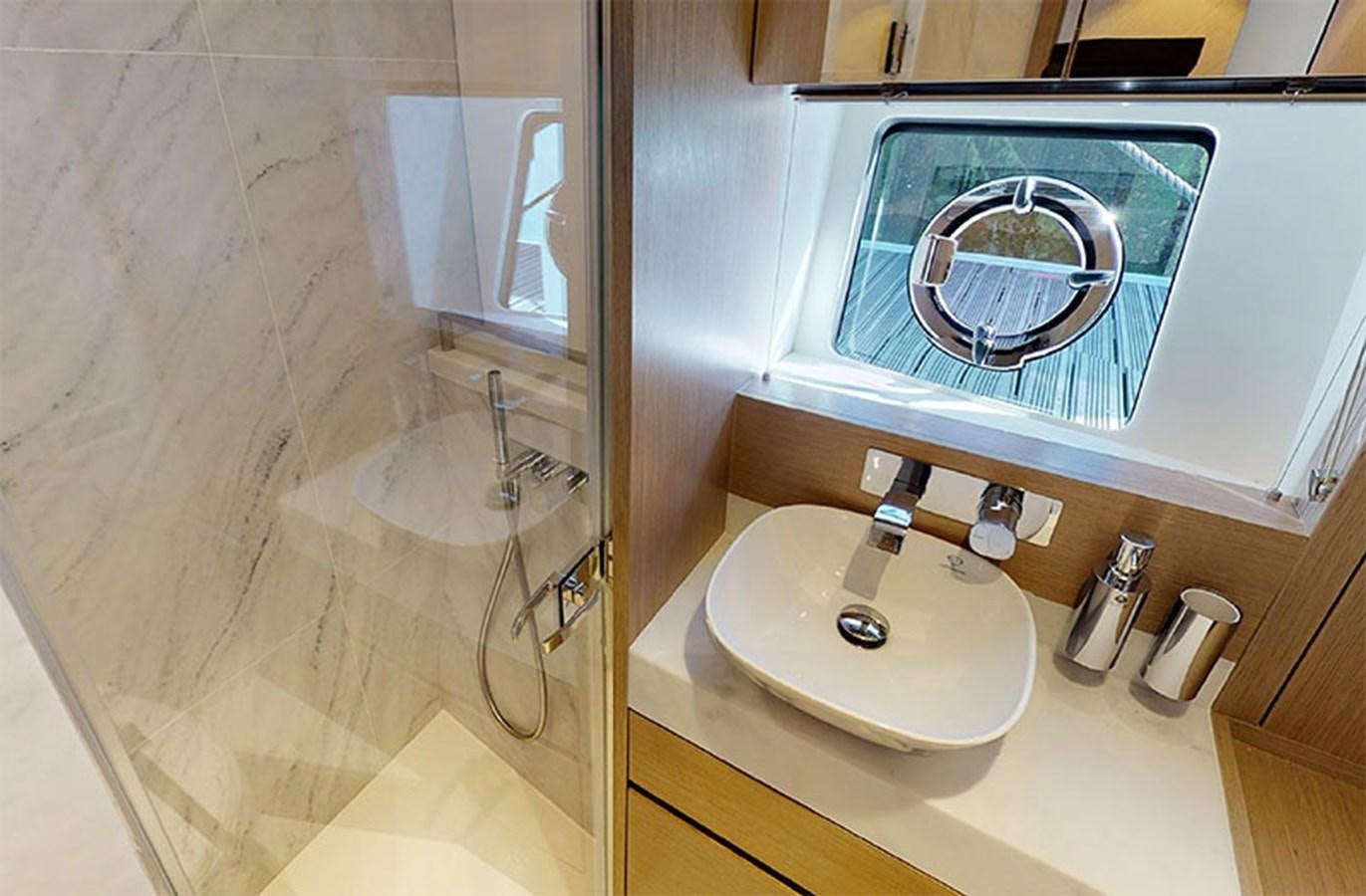a bathroom with a large mirror aboard SM Yacht for Sale