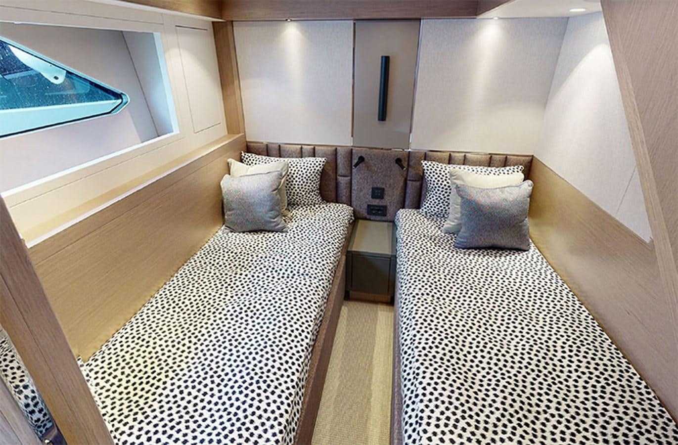 a room with a bed and a television on the wall aboard SM Yacht for Sale