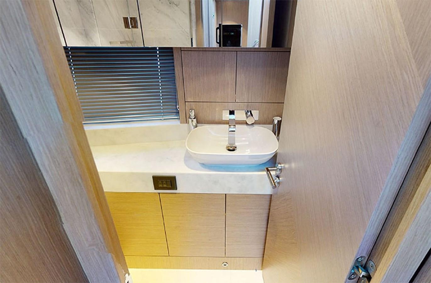 a bathroom with a sink and a mirror aboard SM Yacht for Sale