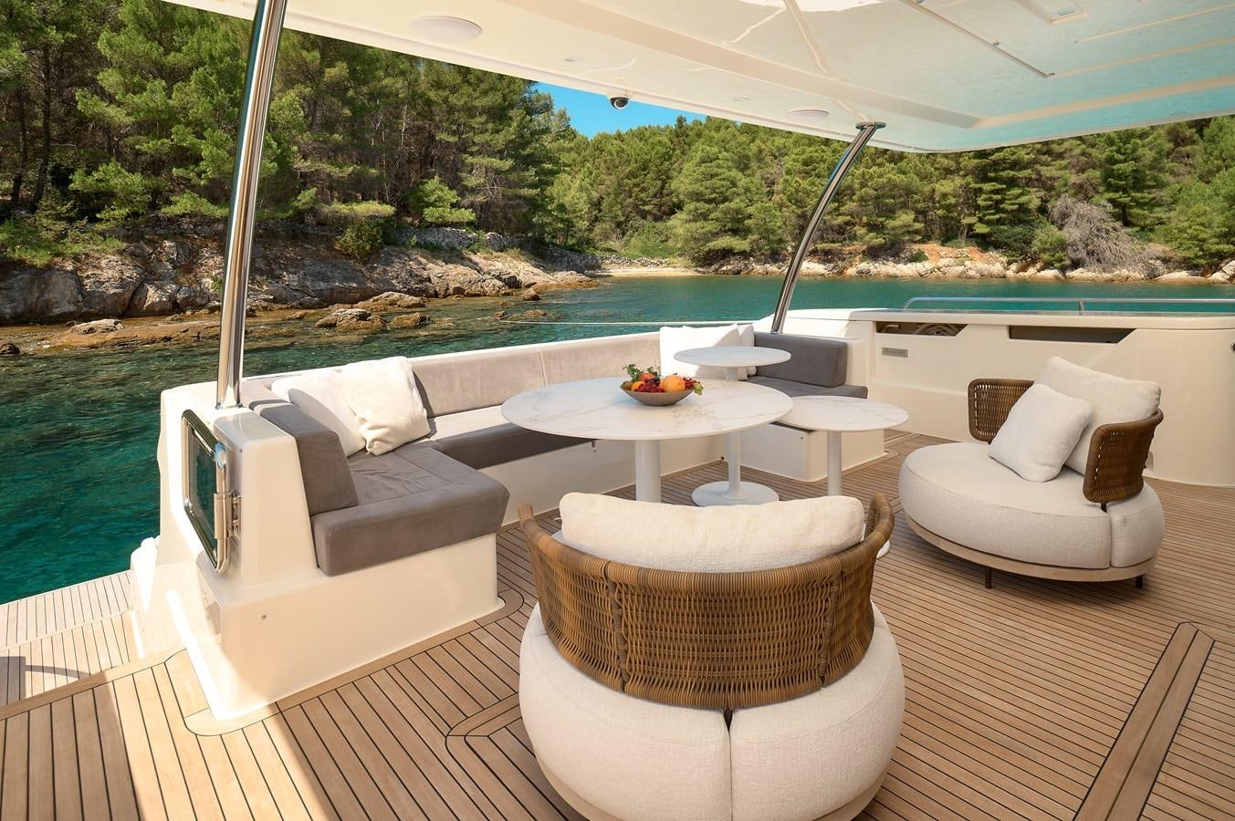 a patio with chairs and tables aboard DAMARI Yacht for Sale