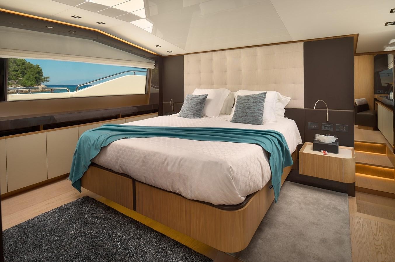 a room with a bed and a window aboard DAMARI Yacht for Sale