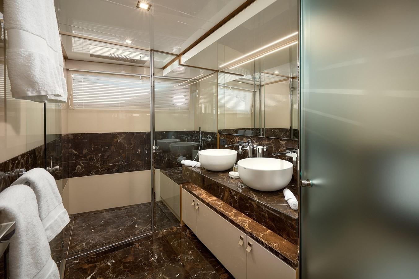 a bathroom with a sink and a bathtub aboard DAMARI Yacht for Sale