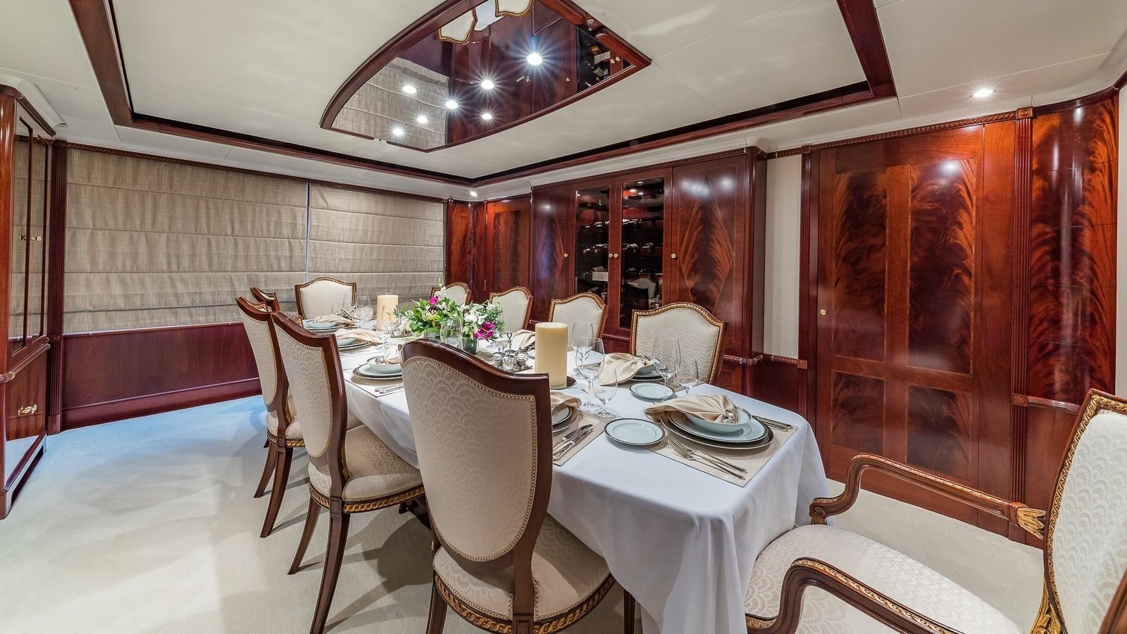 a dining room with a table and chairs aboard BELLA Yacht for Sale