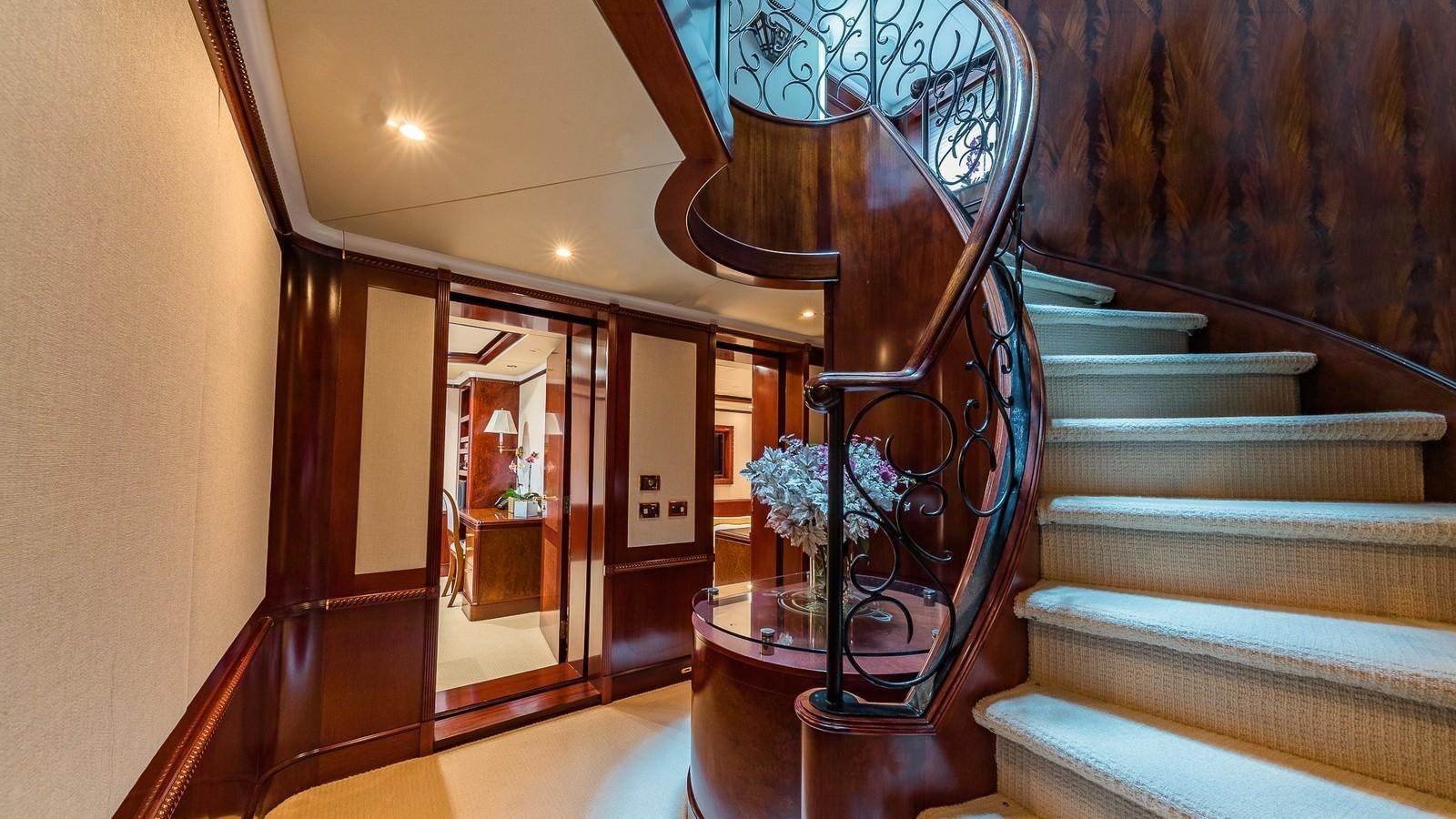 a staircase with a vase of flowers aboard BELLA Yacht for Sale