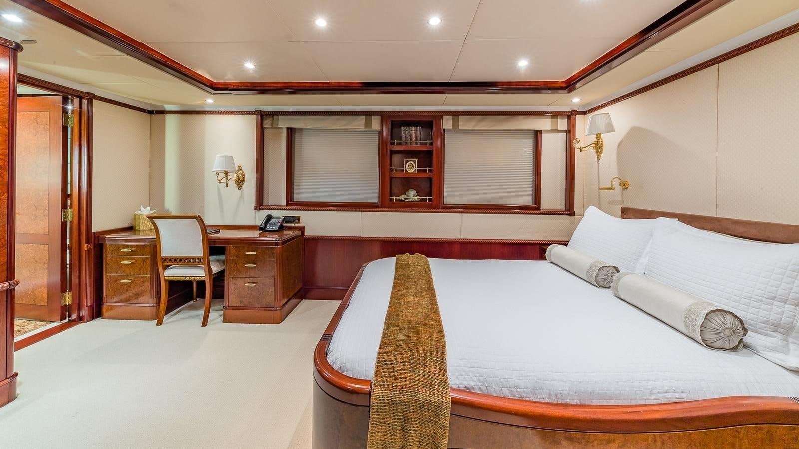 a large bedroom with a bed and a desk aboard BELLA Yacht for Sale