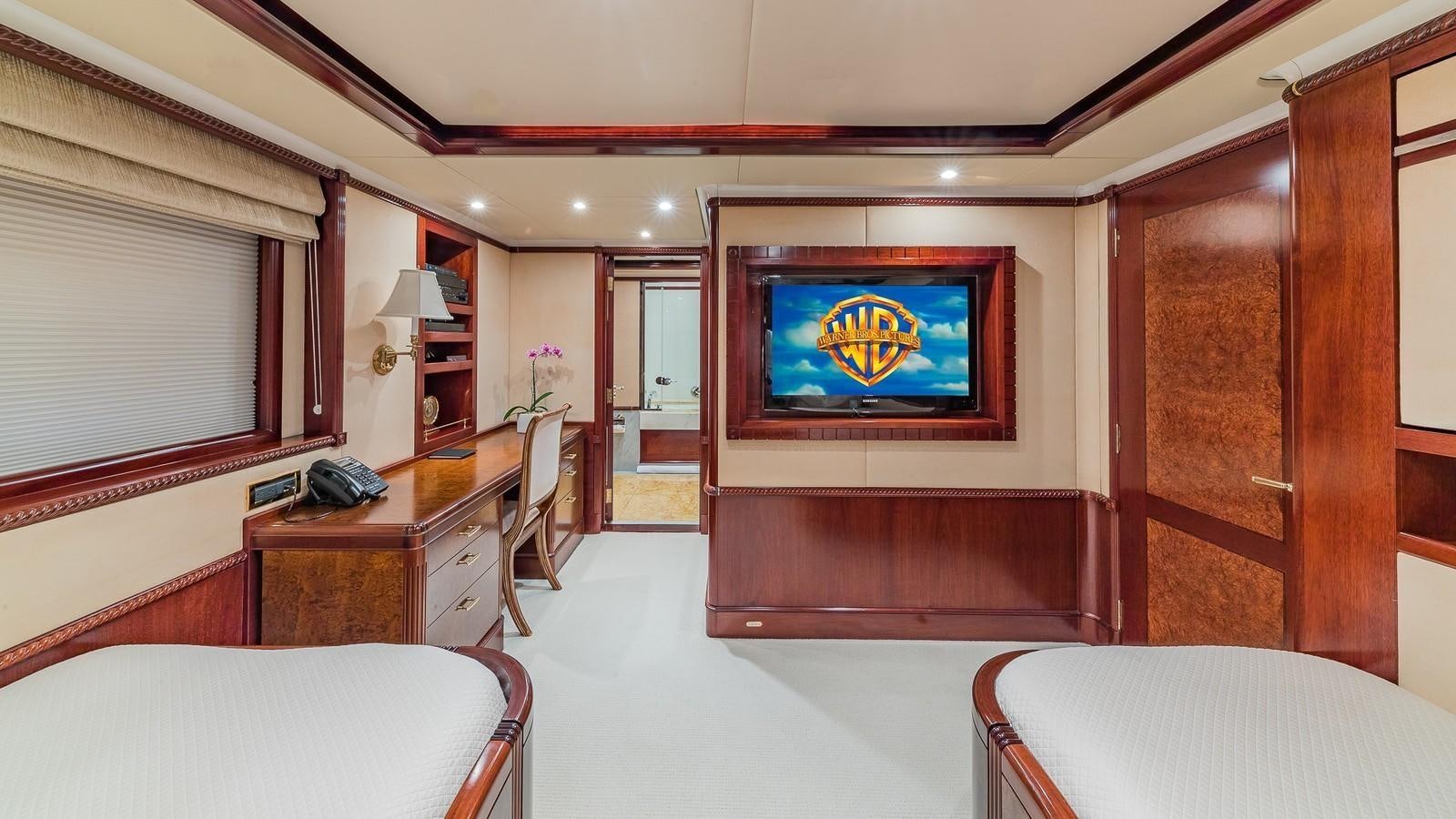 a room with a tv and a bed aboard BELLA Yacht for Sale