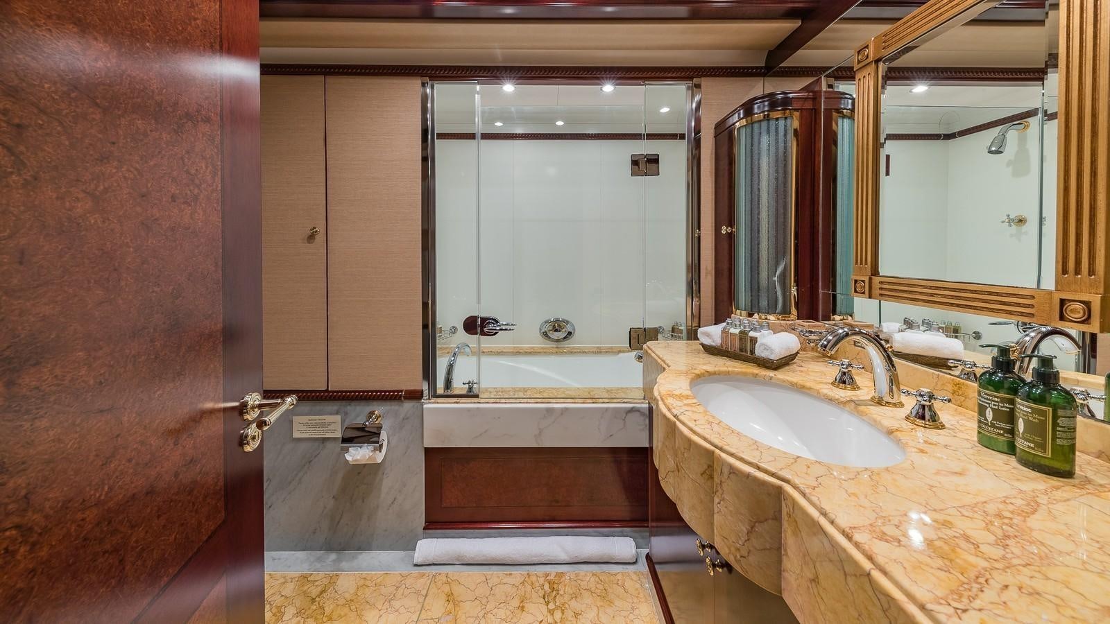 a bathroom with a sink and bathtub aboard BELLA Yacht for Sale
