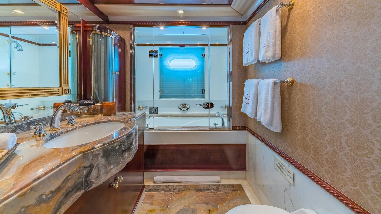a bathroom with a tub sink and a sink aboard BELLA Yacht for Sale