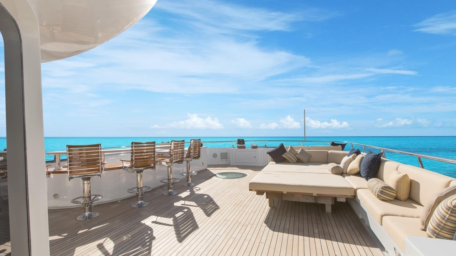 a room with a bed and chairs aboard BELLA Yacht for Sale