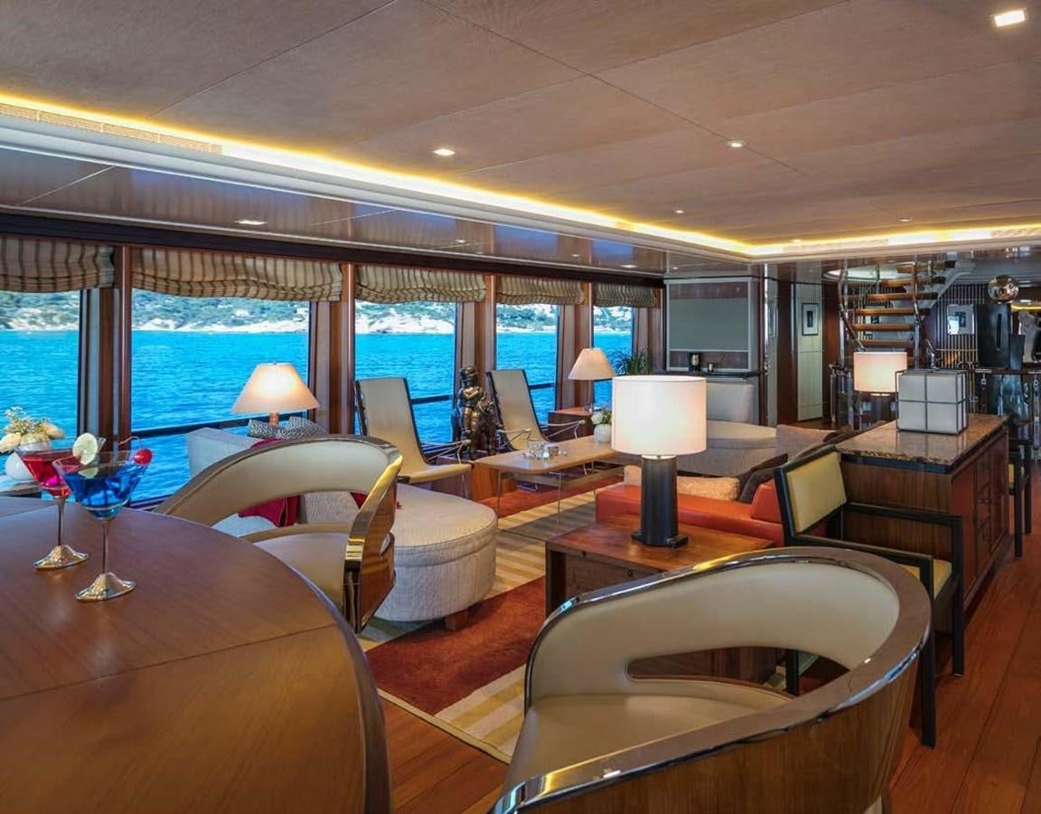 a room with a table chairs and a window with a view of the city aboard PEGASUS Yacht for Sale
