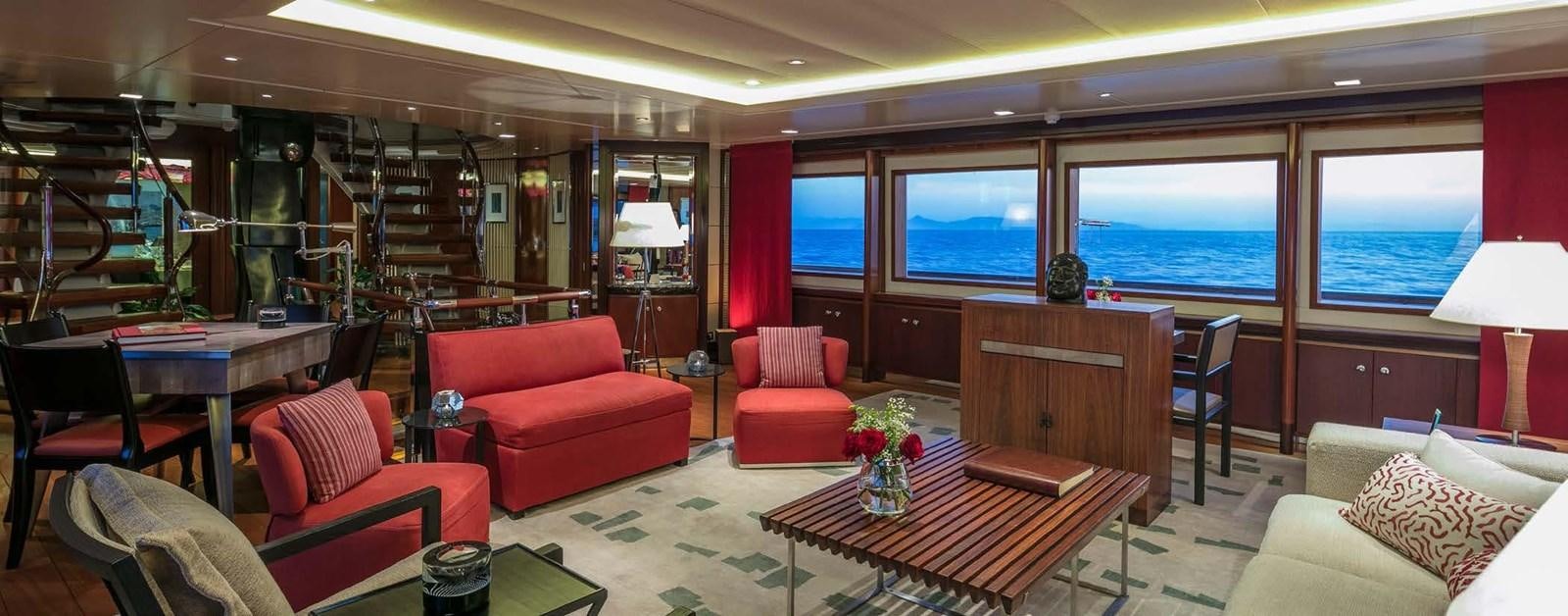 a living room with red furniture aboard PEGASUS Yacht for Sale