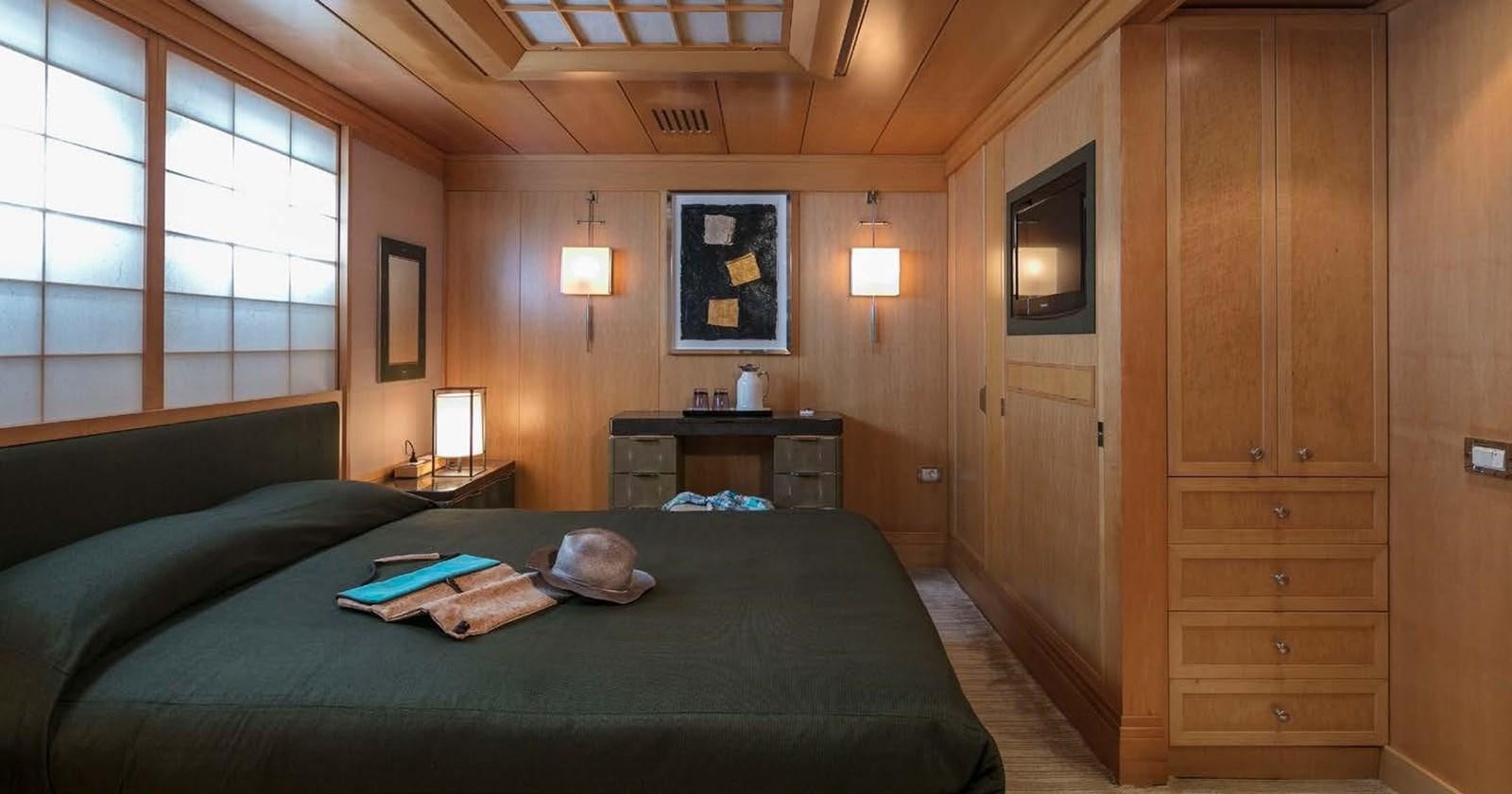 a bedroom with a bed and a desk aboard PEGASUS Yacht for Sale