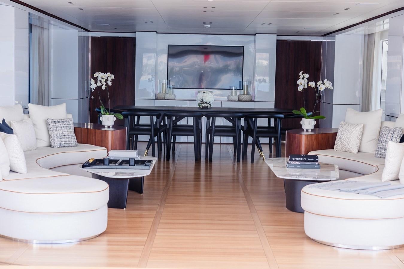 a living room with a table and couches aboard TOSUN Yacht for Sale