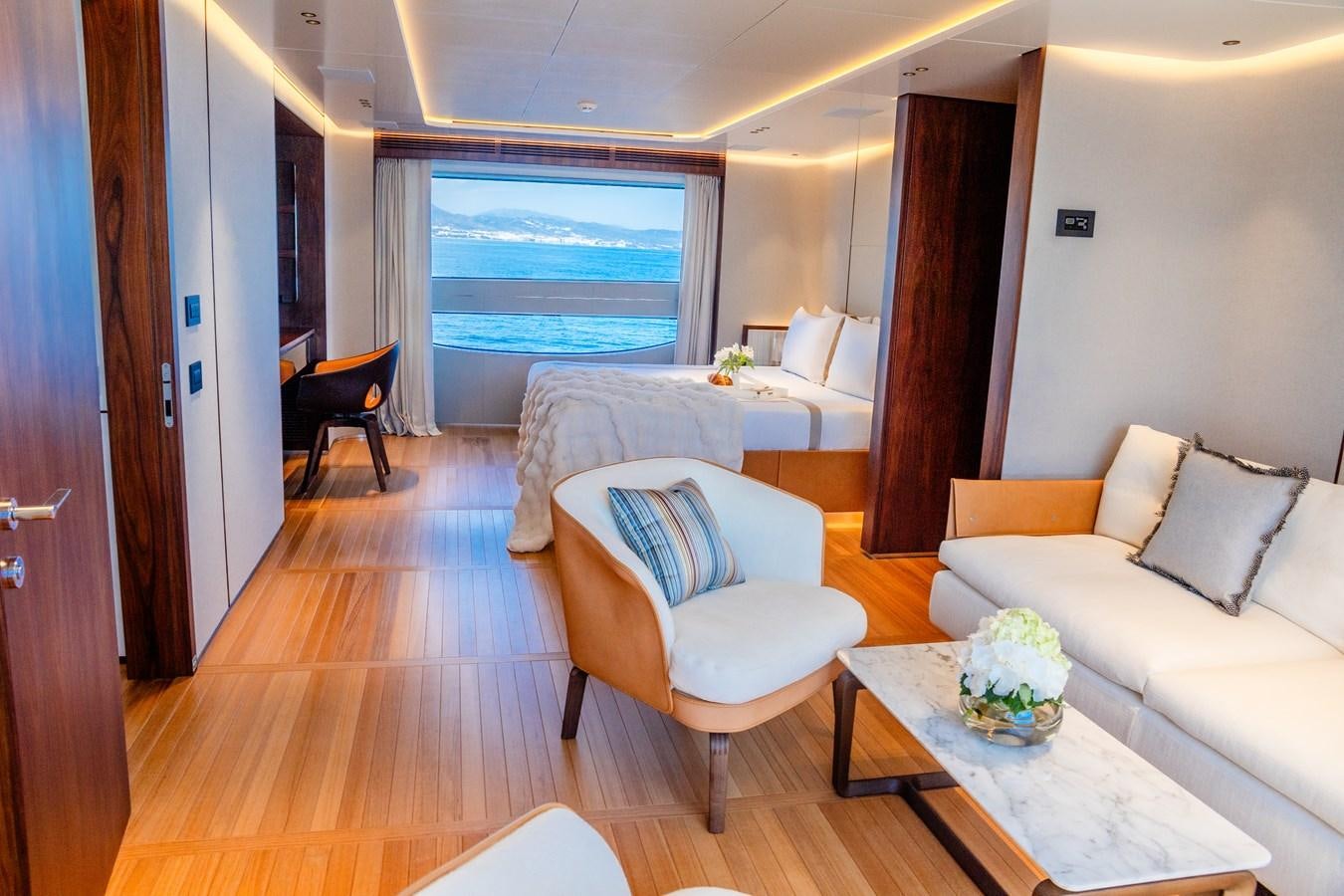 a room with a table chairs and a window aboard TOSUN Yacht for Sale