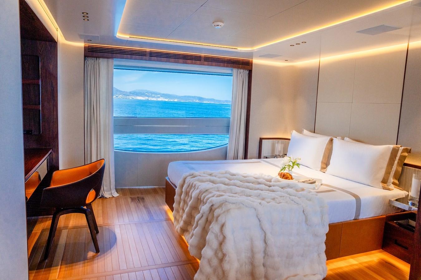 a room with a bed and a window aboard TOSUN Yacht for Sale