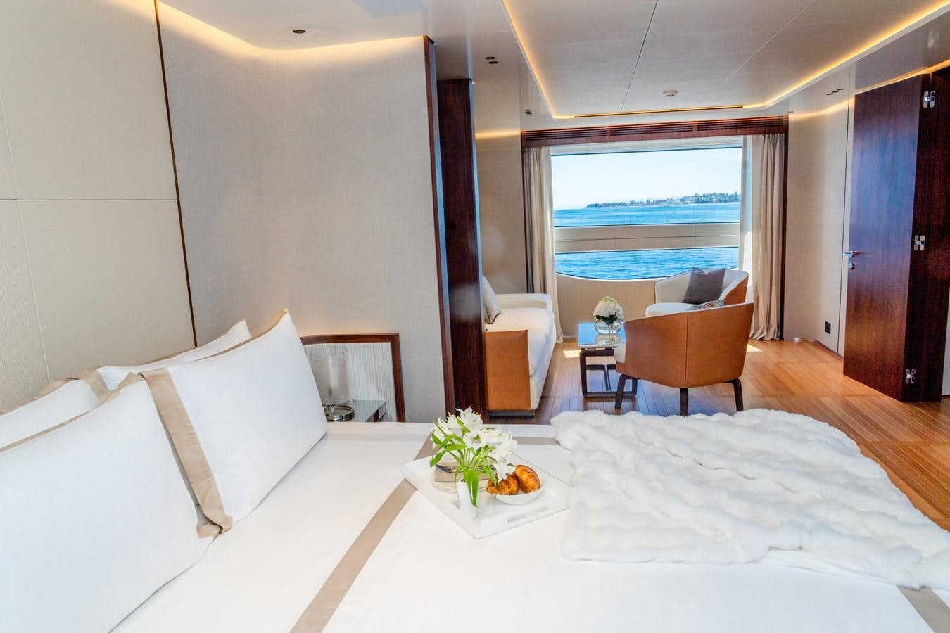 a bed with a white sheet and a white bed spread aboard TOSUN Yacht for Sale