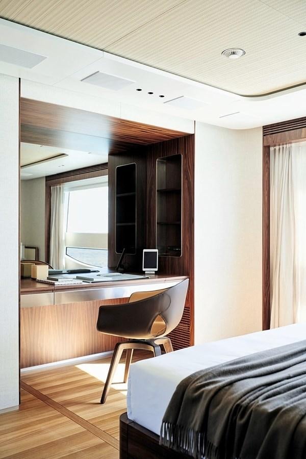 a bedroom with a desk and a bed aboard TOSUN Yacht for Sale