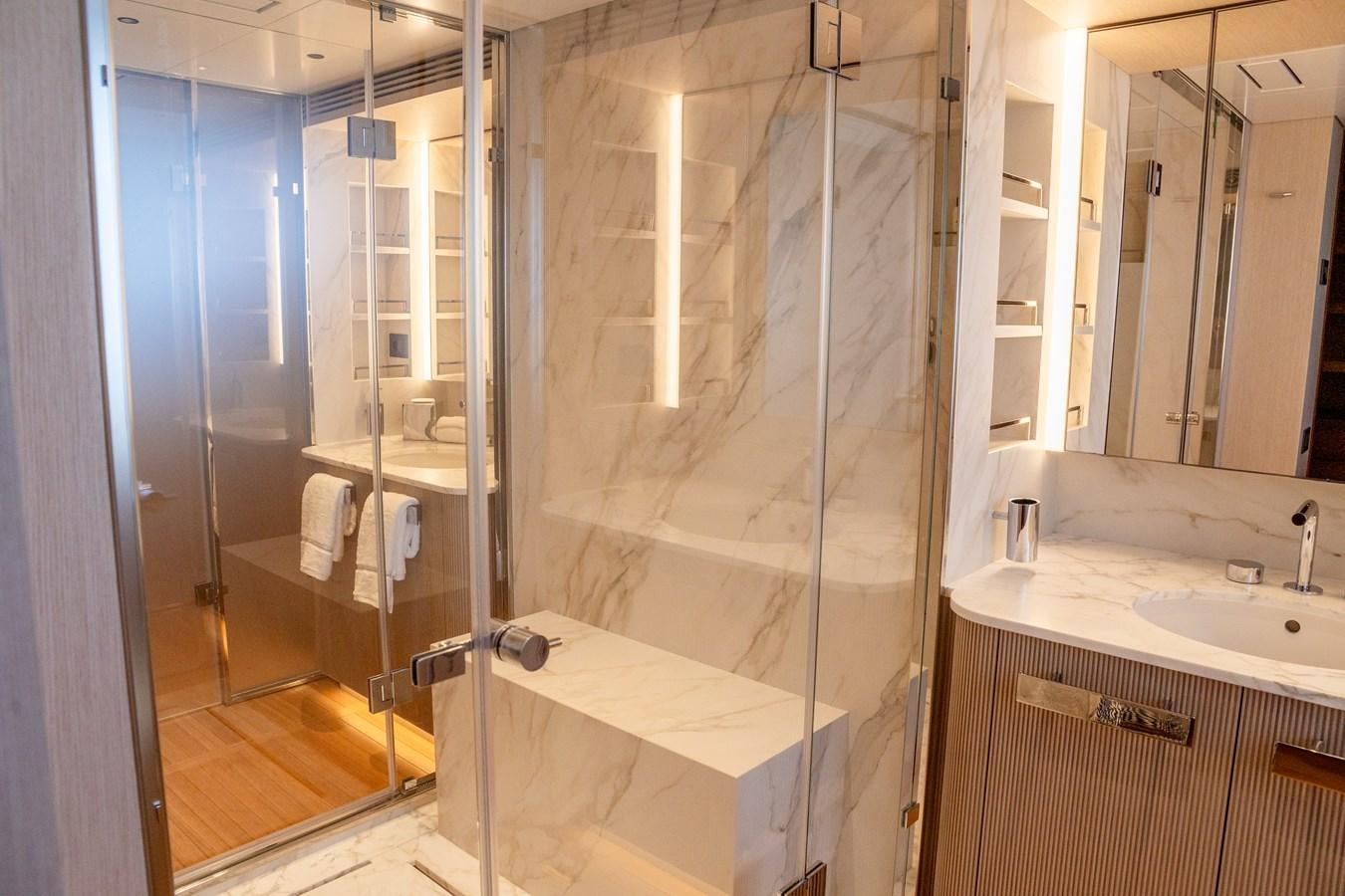 a bathroom with a glass shower aboard TOSUN Yacht for Sale