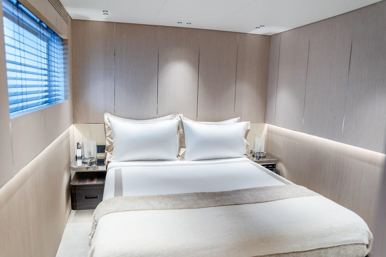 a room with a bed and a window aboard TOSUN Yacht for Sale