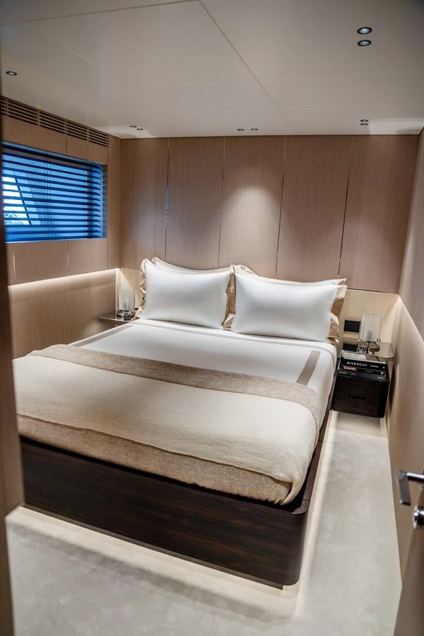 a bed with white sheets aboard TOSUN Yacht for Sale