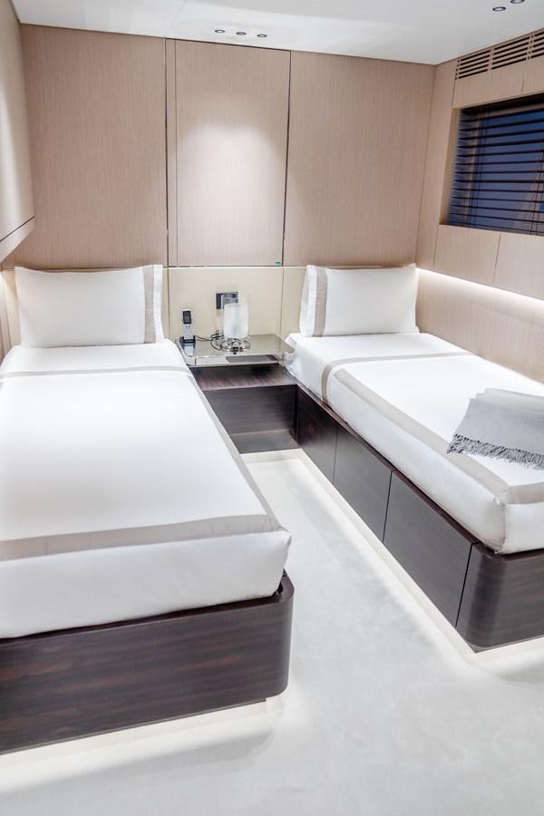 a room with a bed and a desk aboard TOSUN Yacht for Sale