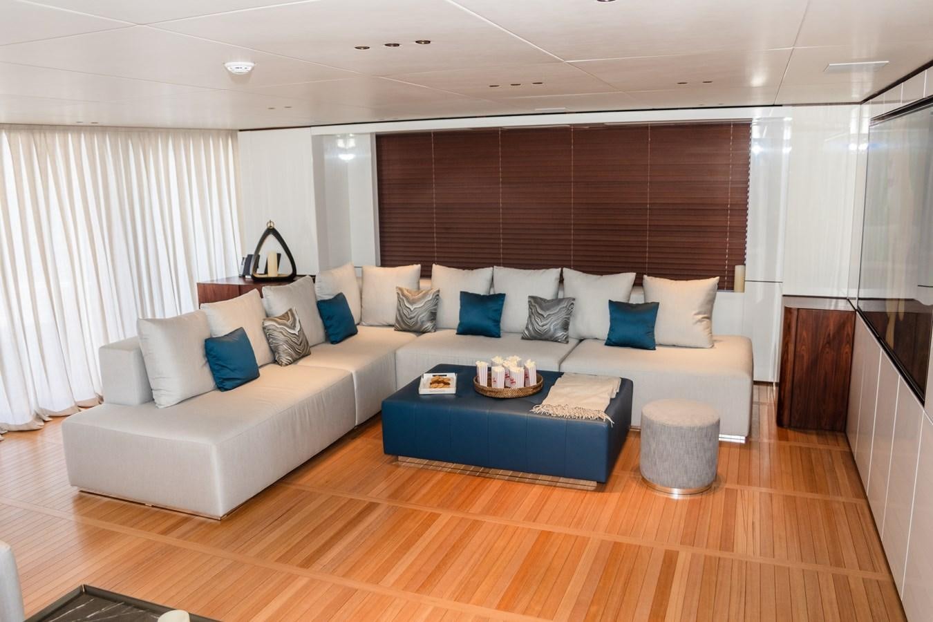 a living room with a couch and a table aboard TOSUN Yacht for Sale