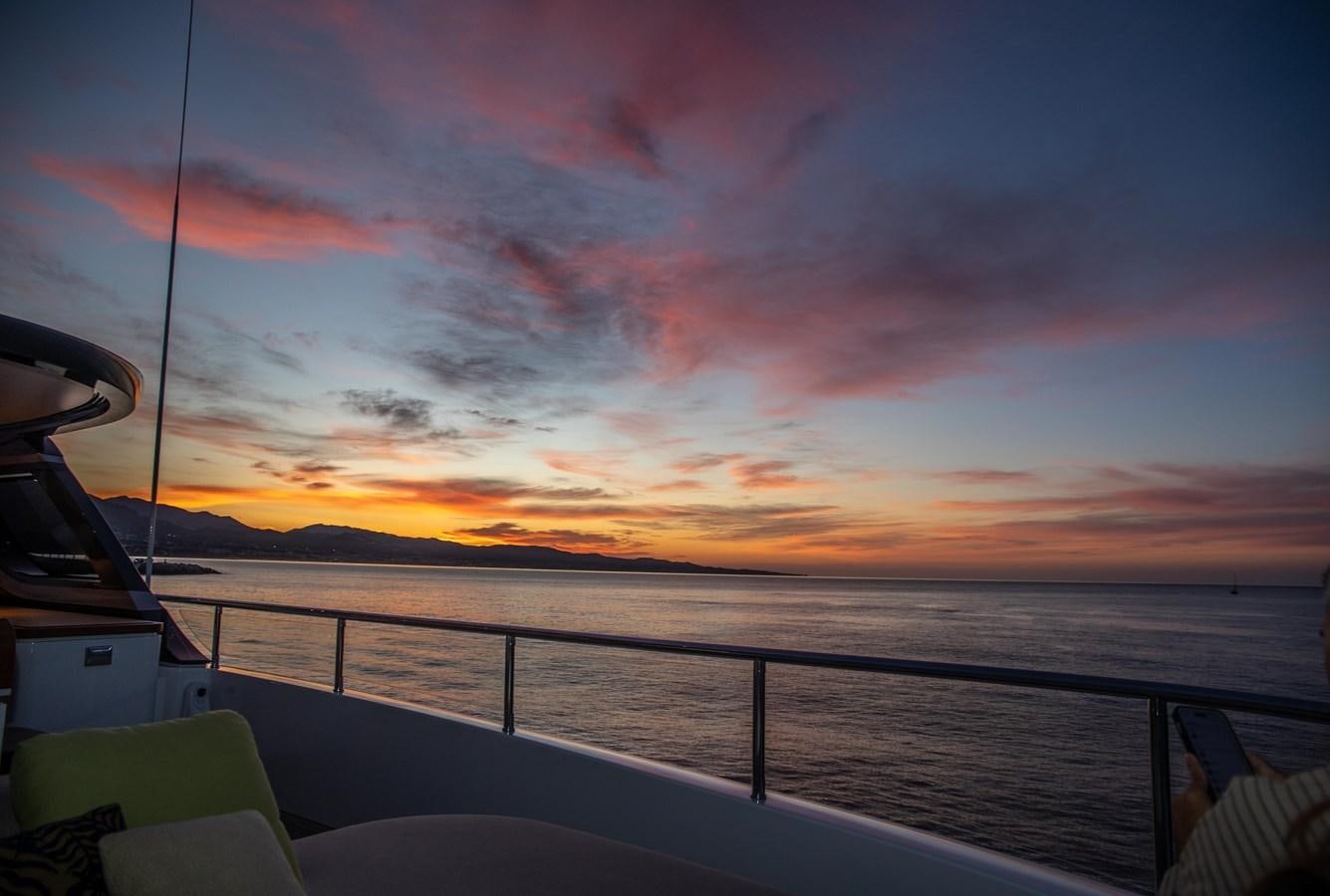 a sunset over a body of water aboard TOSUN Yacht for Sale