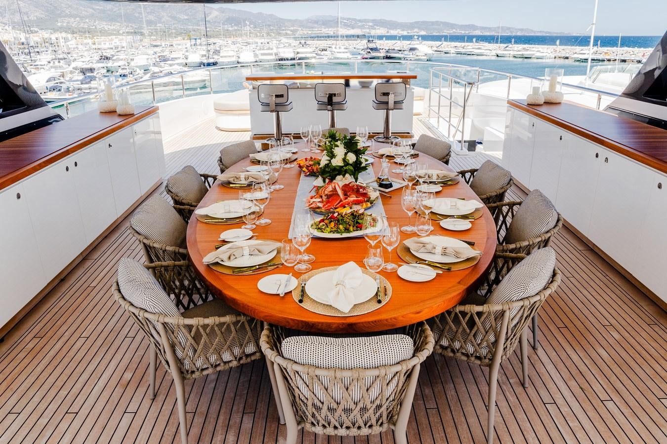 a table set for a meal on a deck aboard TOSUN Yacht for Sale