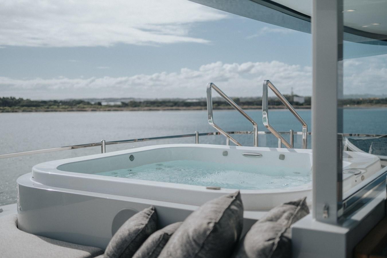 a white boat on a body of water aboard GLOBAS Yacht for Sale