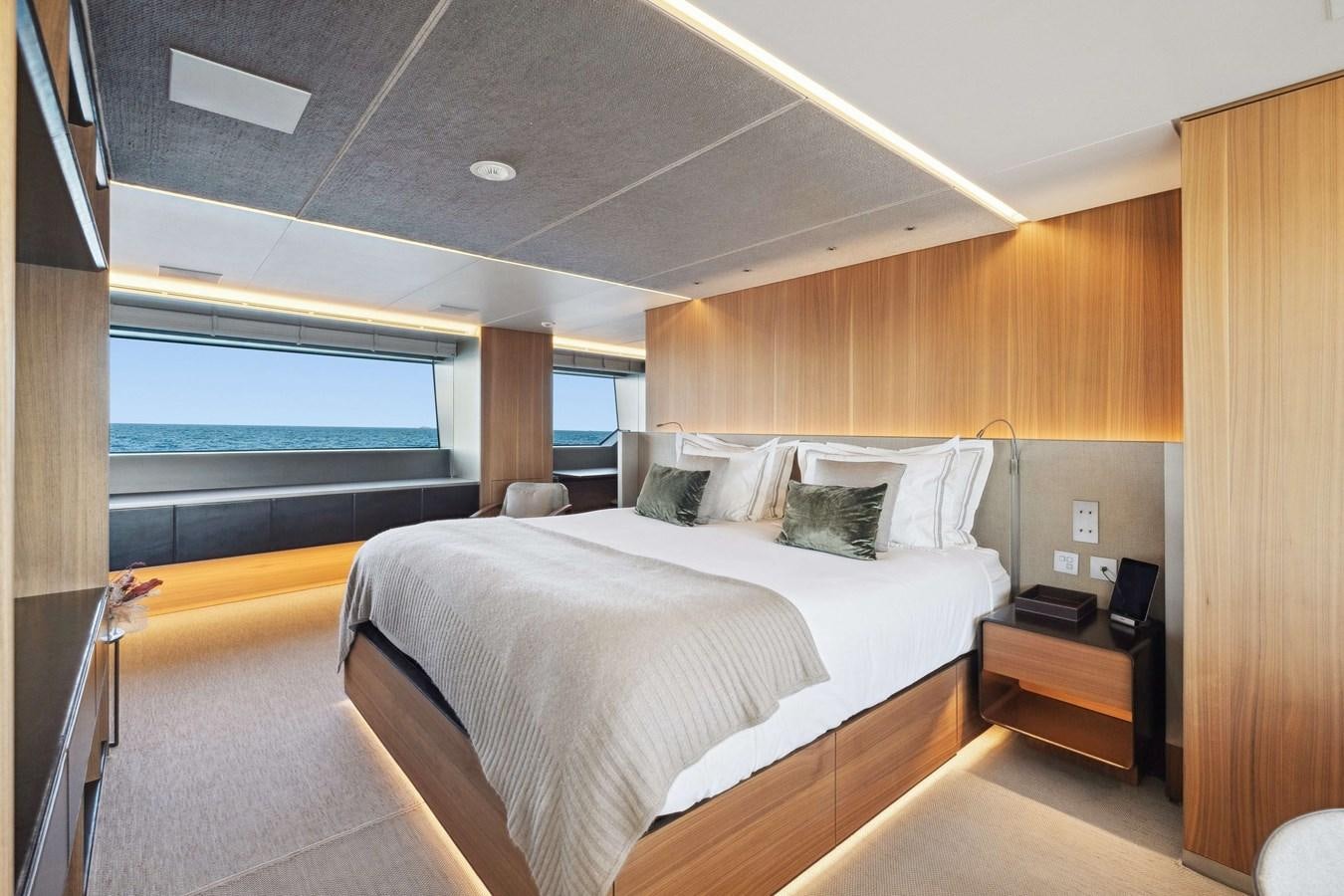a room with a bed and a window aboard GLOBAS Yacht for Sale