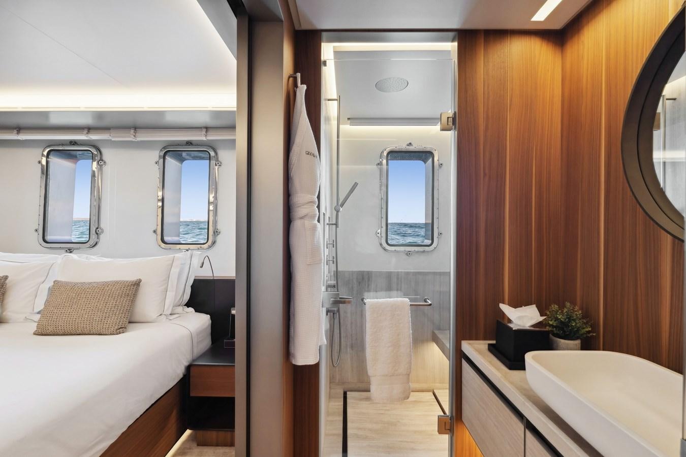 a room with a bed and a mirror aboard GLOBAS Yacht for Sale
