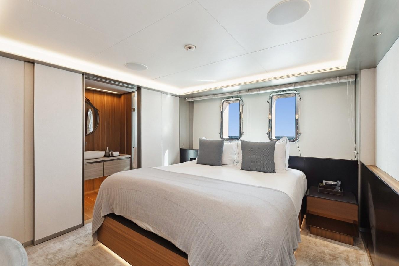 a bedroom with a bed and a mirror aboard GLOBAS Yacht for Sale
