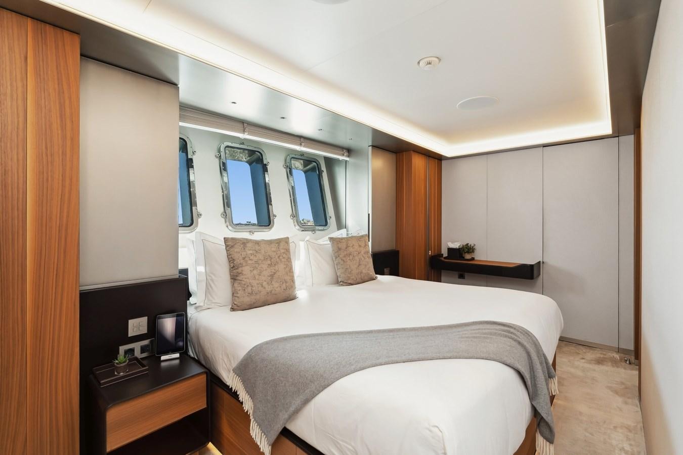 a bedroom with a bed and a desk aboard GLOBAS Yacht for Sale