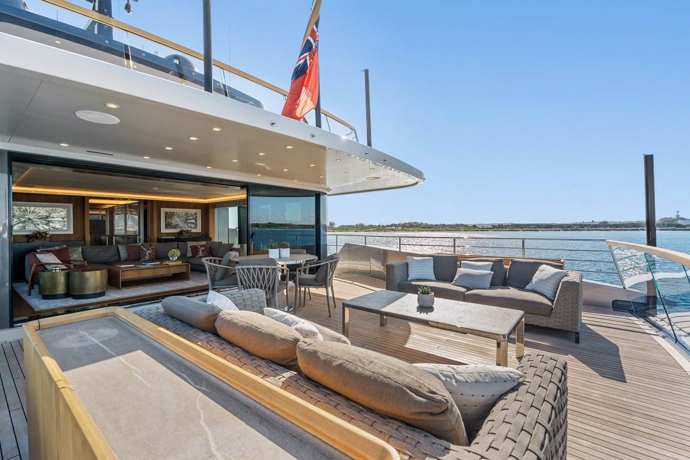 a patio with a table and chairs aboard GLOBAS Yacht for Sale