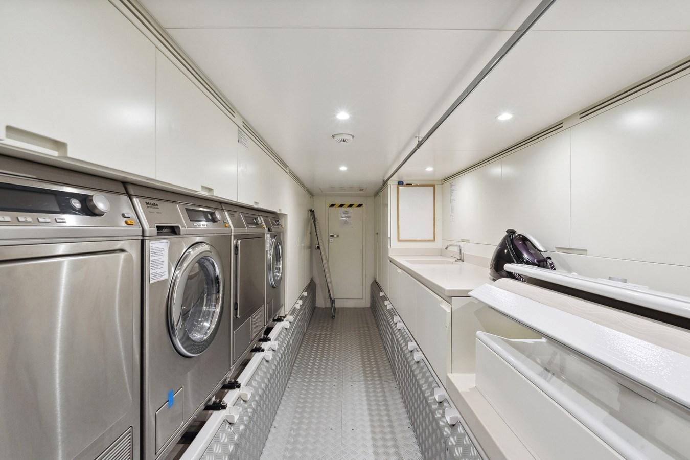 a long hallway with washing machines aboard GLOBAS Yacht for Sale
