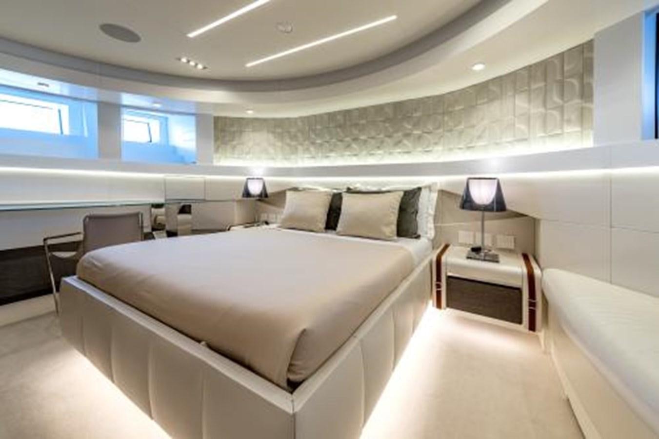 a room with a bed and a desk aboard CABO Yacht for Sale