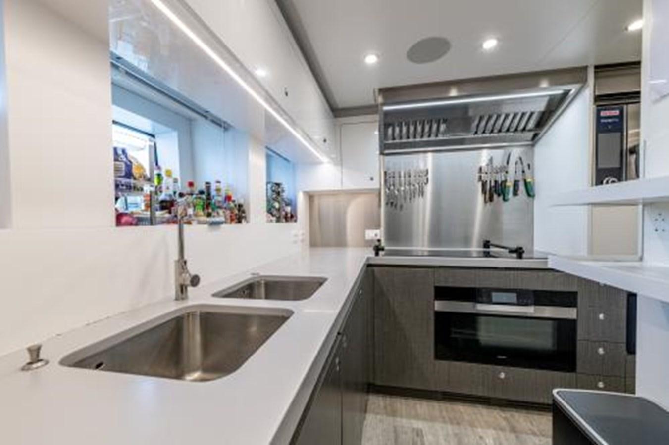 a kitchen with a sink and a stove aboard CABO Yacht for Sale